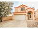 Charming two-story home featuring a two-car garage, arched entryway and desert landscaping at 1604 Tamborine Ct, Las Vegas, NV 89128