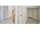 Hallway with staircase, tile flooring and doorway into a closet with shelving at 1604 Tamborine Ct, Las Vegas, NV 89128
