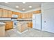 Functional kitchen with wooden cabinets, a center island, and modern appliances providing an efficient cooking space at 1604 Tamborine Ct, Las Vegas, NV 89128