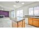 Open-concept kitchen with an island, ample counter space, and seamless flow to the living area, great for entertaining at 1604 Tamborine Ct, Las Vegas, NV 89128