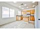 Well-lit kitchen featuring a practical layout, wooden cabinetry, and tile flooring for easy maintenance at 1604 Tamborine Ct, Las Vegas, NV 89128