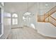 Bright and airy living space with high ceilings, modern light fixtures, and beautiful flooring at 1604 Tamborine Ct, Las Vegas, NV 89128