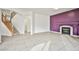Open-concept living area with neutral tile flooring and a decorative fireplace with purple accent wall at 1604 Tamborine Ct, Las Vegas, NV 89128