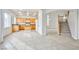 Well-lit open concept space with tile floors, open access to kitchen and view of staircase at 1604 Tamborine Ct, Las Vegas, NV 89128