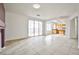 Living room with tile floors, sliding glass doors and open access to the kitchen area at 1604 Tamborine Ct, Las Vegas, NV 89128