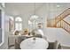 Bright living room featuring vaulted ceilings, stylish decor, and large windows, creating an inviting atmosphere at 1604 Tamborine Ct, Las Vegas, NV 89128