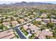 An aerial shot of a residential neighborhood with houses, golf course and views of the mountains at 17 Winding Rd, Henderson, NV 89052
