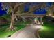 Backyard with a covered patio, lush landscaping, and a winding stone path at 17 Winding Rd, Henderson, NV 89052