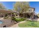 Expansive backyard with putting green, pergola, outdoor kitchen, and mature landscaping at 17 Winding Rd, Henderson, NV 89052