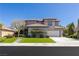 Lovely two-story home with manicured landscaping, a walkway to the arched entrance, and a three-car garage at 17 Winding Rd, Henderson, NV 89052