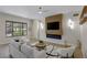 Inviting living room featuring a modern fireplace, mounted TV and comfortable seating at 17 Winding Rd, Henderson, NV 89052