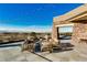 Outdoor patio with stone accents, mountain views, and comfortable seating beneath string lights at 17 Winding Rd, Henderson, NV 89052