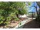 This home features a backyard with a beautiful canopy tree and a quaint outdoor patio area at 1878 Corvette St, Las Vegas, NV 89142