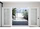 Backyard view featuring French doors to the house, a trellis, and ample shade at 1878 Corvette St, Las Vegas, NV 89142