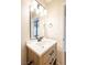 Contemporary bathroom features a wood cabinet vanity, white countertop, and stylish black fixtures at 1878 Corvette St, Las Vegas, NV 89142