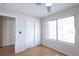 Bright bedroom with wood floors, sliding closet doors, and a window overlooking the backyard at 1878 Corvette St, Las Vegas, NV 89142