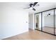 This is a bedroom that features mirrored closet doors, a modern ceiling fan, and beautiful wood floors at 1878 Corvette St, Las Vegas, NV 89142