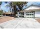 Charming home with a large driveway and a green-accented garage door at 1878 Corvette St, Las Vegas, NV 89142