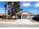 Charming single-story home with a two-car garage, palm tree, and well-maintained front yard at 1878 Corvette St, Las Vegas, NV 89142