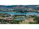 Scenic view of waterfront homes, a blue lake, and picturesque mountains in the distance at 20 Via Paradiso St, Henderson, NV 89011
