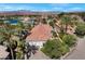 Expansive property with lake views, red tile roof, mature trees, and brick driveway at 20 Via Paradiso St, Henderson, NV 89011