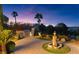 Beautiful backyard oasis featuring an outdoor kitchen, lush landscaping, and an ornate fountain at 20 Via Paradiso St, Henderson, NV 89011