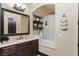 Elegant bathroom with dark wood cabinetry, a marble countertop, and decor shelving, creating a warm and inviting space at 20 Via Paradiso St, Henderson, NV 89011