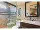 Elegant bathroom featuring a glass enclosed shower, decorative tile accents, and a dark wood vanity at 20 Via Paradiso St, Henderson, NV 89011