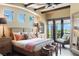 Bright bedroom with wood beamed ceiling, large window views, and stylish neutral decor at 20 Via Paradiso St, Henderson, NV 89011