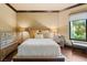 Well-lit bedroom with hardwood floors, a large window, and decorative bedside tables at 20 Via Paradiso St, Henderson, NV 89011