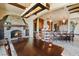 Elegant dining area with a stone fireplace, wood beams, and an open view to the kitchen at 20 Via Paradiso St, Henderson, NV 89011
