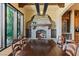 Dining area with a stone fireplace, long table with six chairs, and elegant décor at 20 Via Paradiso St, Henderson, NV 89011