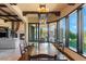 Bright dining room featuring a long wooden table, large windows with picturesque views, and stylish lighting at 20 Via Paradiso St, Henderson, NV 89011
