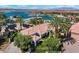 Beautiful single-story home with red tile roof, lush landscaping, and a well-manicured lawn at 20 Via Paradiso St, Henderson, NV 89011