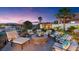 Inviting backyard firepit with comfortable seating, surrounded by lush greenery and scenic views at 20 Via Paradiso St, Henderson, NV 89011