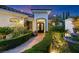 Charming home entrance with manicured hedges, a stone pathway, and ornate ironwork doors at 20 Via Paradiso St, Henderson, NV 89011