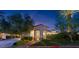Elegant front entrance with arched portico, lush landscaping, and a charming walkway at 20 Via Paradiso St, Henderson, NV 89011