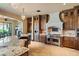 Well-appointed kitchen with a stone hood, stainless steel appliances, and seamless granite countertops at 20 Via Paradiso St, Henderson, NV 89011