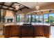 Gourmet kitchen featuring a large island, custom cabinetry, and modern appliances with an open floorplan at 20 Via Paradiso St, Henderson, NV 89011
