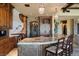 Gourmet kitchen featuring custom wood cabinetry, stone accents, and a granite countertop island with seating at 20 Via Paradiso St, Henderson, NV 89011