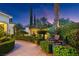 Lush landscaped yard featuring a fountain, seating area, and meticulously maintained hedges at 20 Via Paradiso St, Henderson, NV 89011