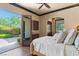 Bright and airy main bedroom with French doors leading to a patio with a lush landscape at 20 Via Paradiso St, Henderson, NV 89011