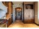 Elegant pantry area with wooden cabinetry, granite counters, stone accents, and a built-in wine cooler at 20 Via Paradiso St, Henderson, NV 89011