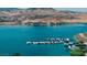 Lakefront view of a marina with boats docked, mountains, and buildings in the background at 20 Via Paradiso St, Henderson, NV 89011