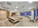 Bright game room boasts a pool table, lounge area, and floor to ceiling windows with skyline views at 200 Hoover Ave # 1905, Las Vegas, NV 89101