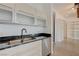 Close up of kitchen sink and cabinets with modern stainless steel dishwasher and hardware at 200 Hoover Ave # 1905, Las Vegas, NV 89101