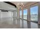 Open living area offers panoramic city views through large windows and a modern industrial design at 200 Hoover Ave # 1905, Las Vegas, NV 89101