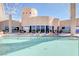 Rooftop pool has lounge chairs and tables with partial building and shade structure views at 200 Hoover Ave # 1905, Las Vegas, NV 89101