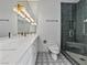 Luxurious bathroom featuring double sinks, marble countertops, and stylish tiling at 21 Sawgrass Ct, Las Vegas, NV 89113