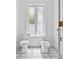 Stylish bathroom with a bidet, toilet, and beautiful black and white patterned tile floor, illuminated by a frosted glass window at 21 Sawgrass Ct, Las Vegas, NV 89113
